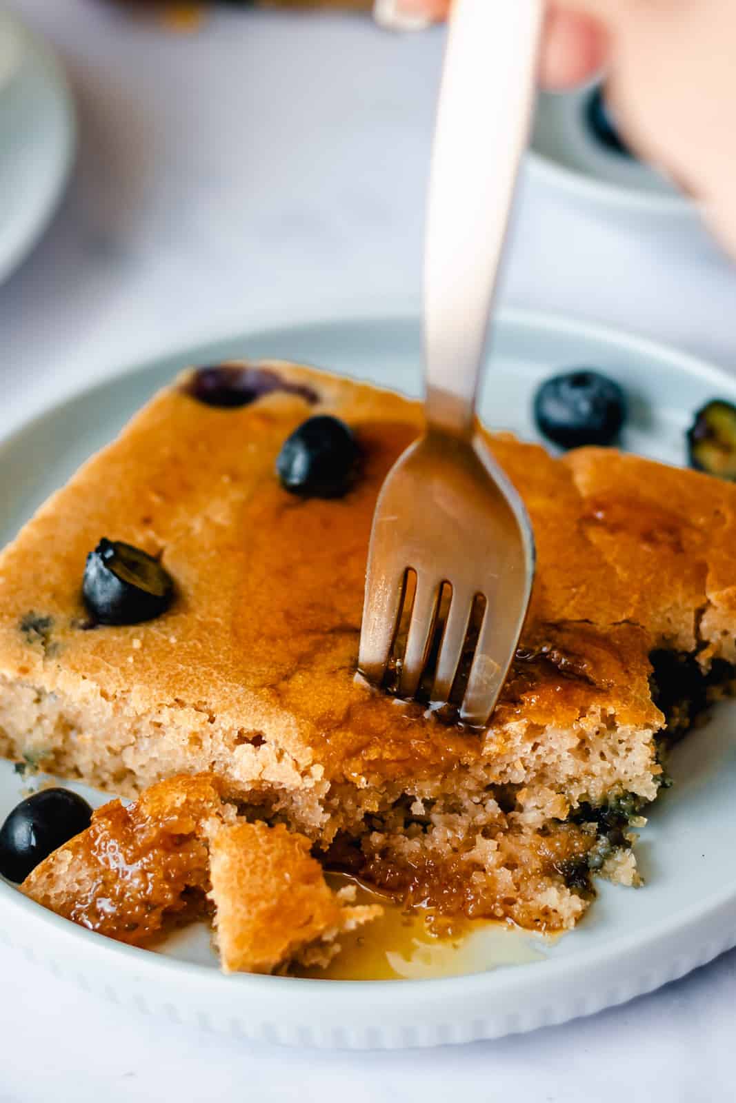 fork digging into blueberry sheet pan pancakes