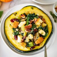 halved stuffed acorn squash on a plate