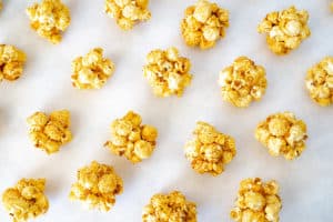 maple caramel popcorn balls on parchment paper