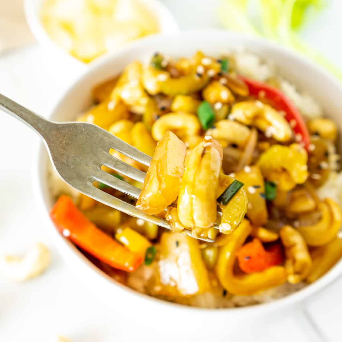 stir fried cashew and pineapple pieces on a fork