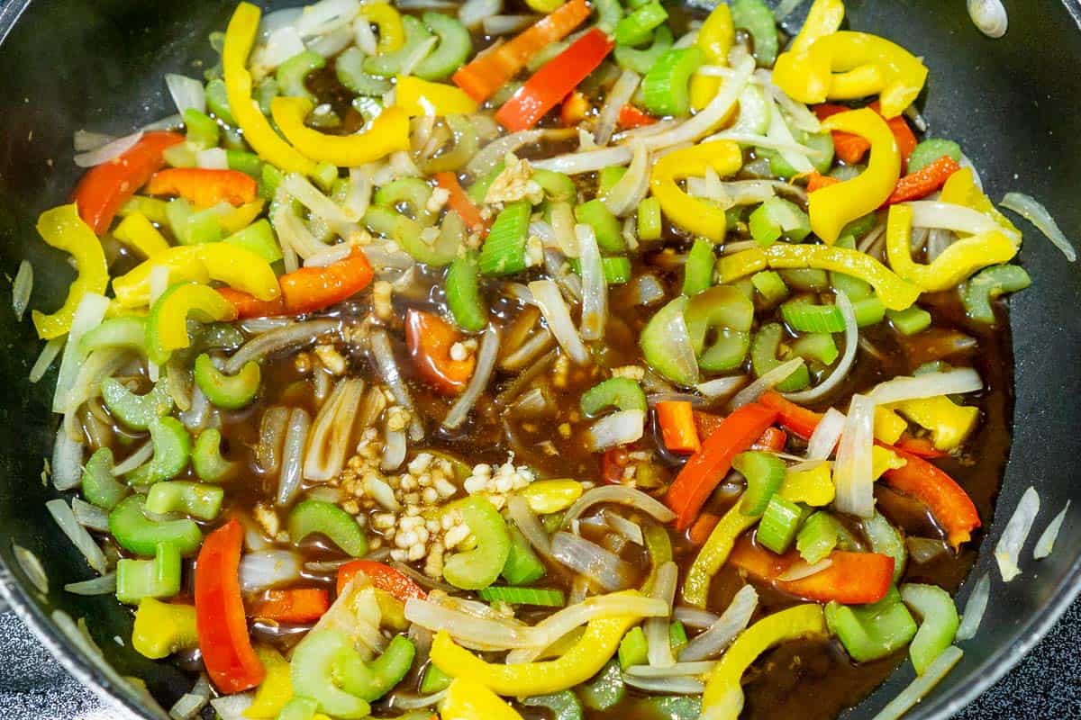 bell peppers, cashews, celery and pineapple sauce in a pan
