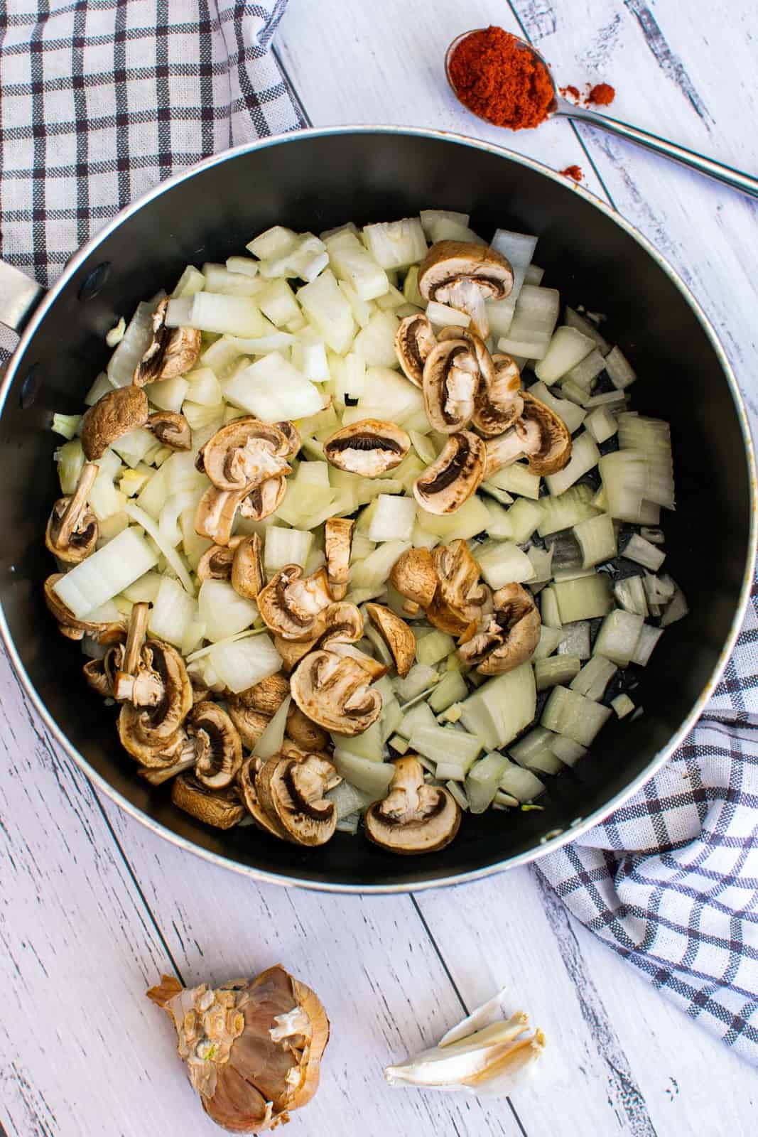 sautéing sliced mushrooms and diced onion in a pan