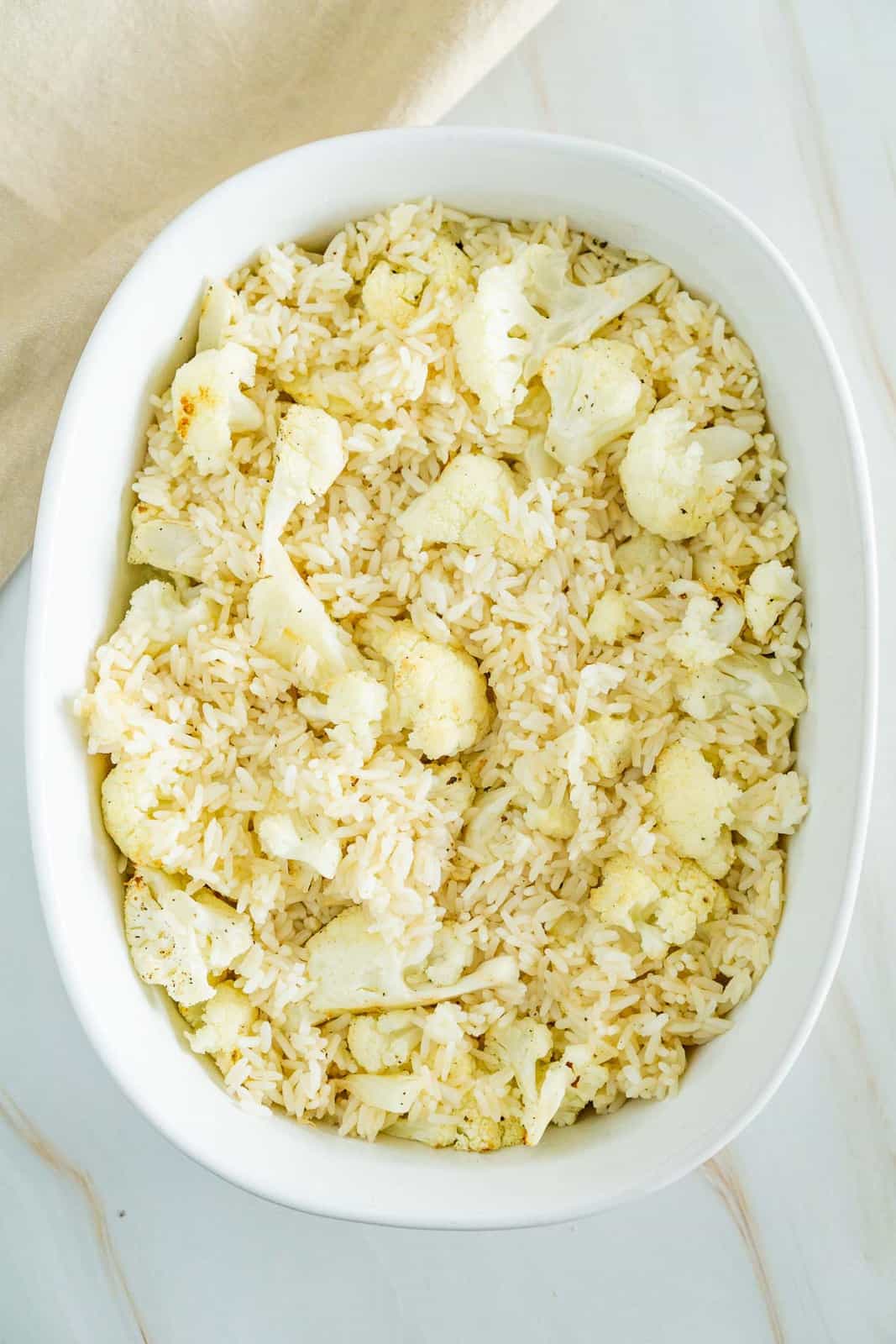 cauliflower florets and cooked rice in a casserole pan