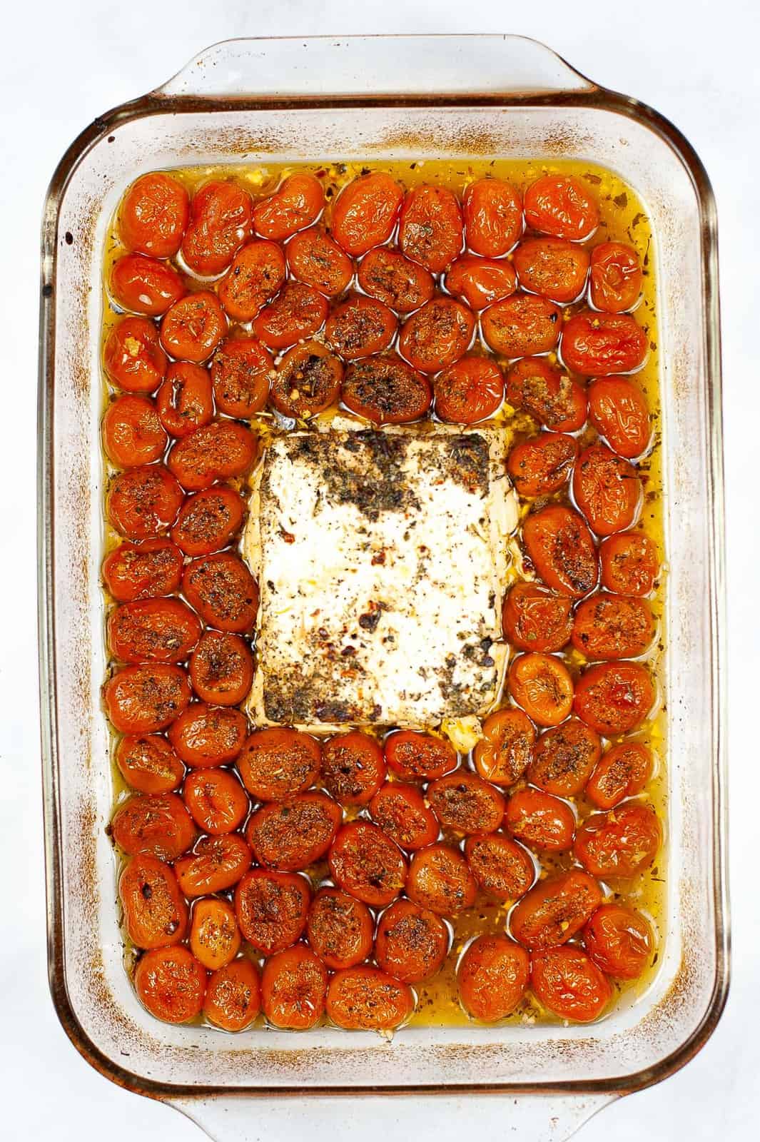 Baked vegan feta and tomatoes in a pan. 