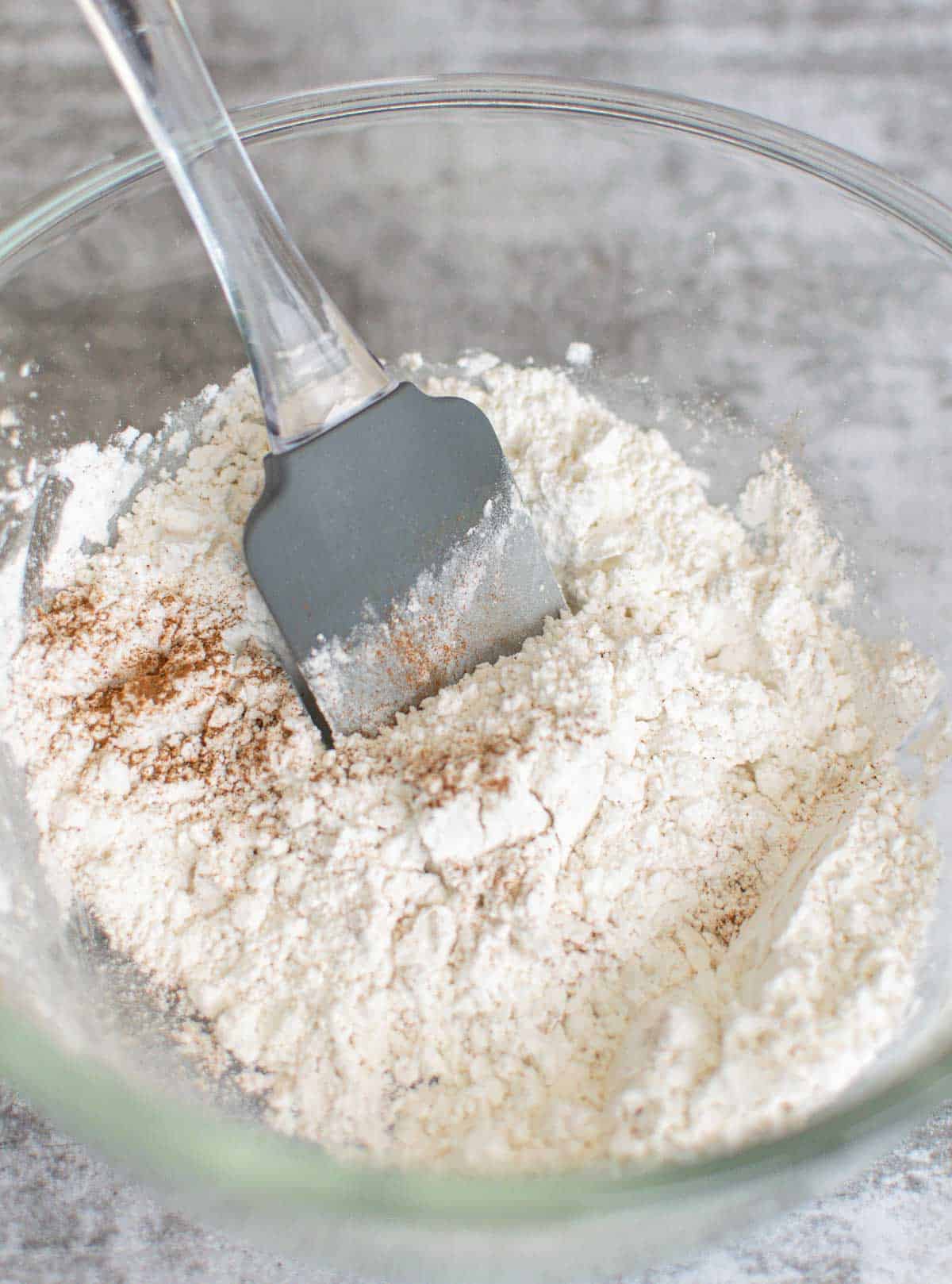 Gluten-free flour mixed with cinnamon in a bowl.