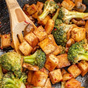 Broccoli and tofu stir fry in a wok.