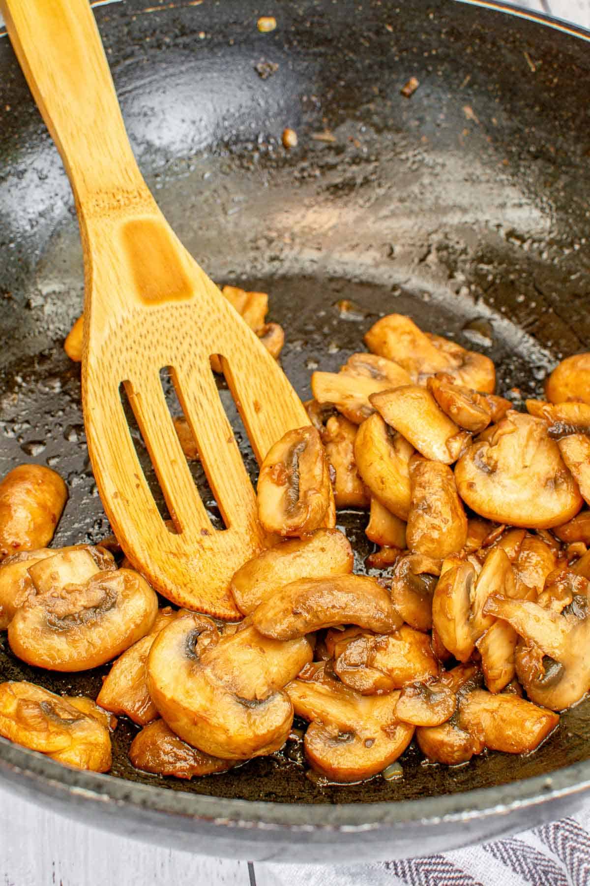 Sauteed mushrooms in a wok.