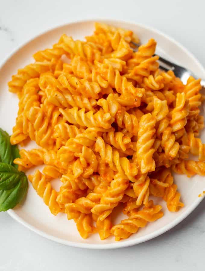 Plate of pasta with vegan roasted red pepper sauce.