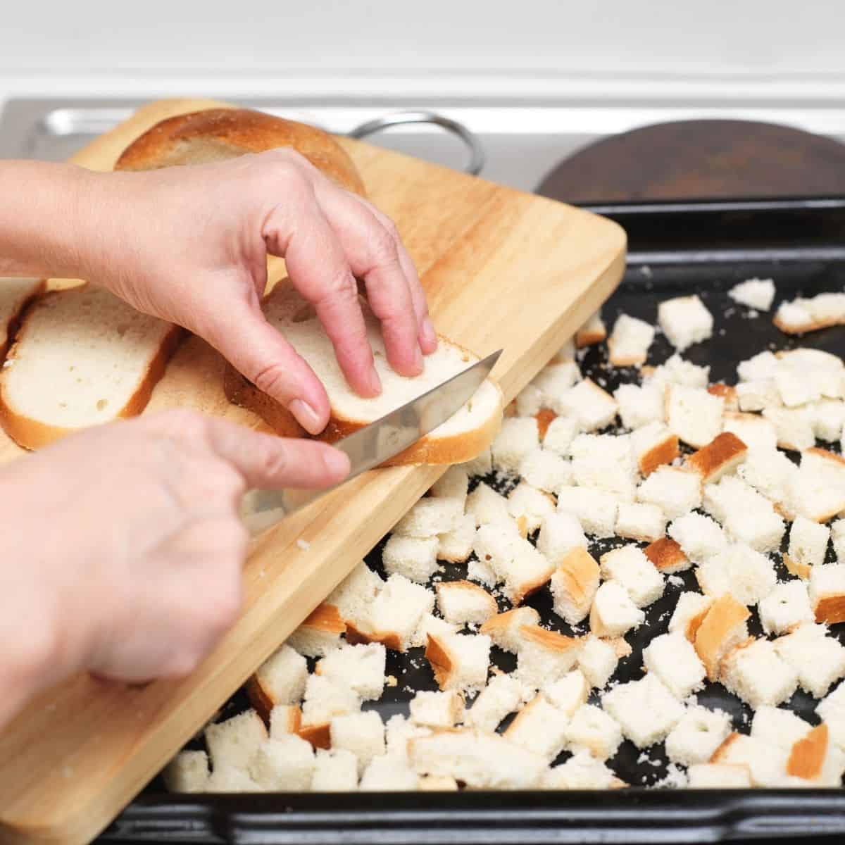 Added bread cubes to a baking tray.