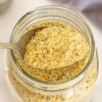 A spoon scooping vegan Italian breadcrumbs.