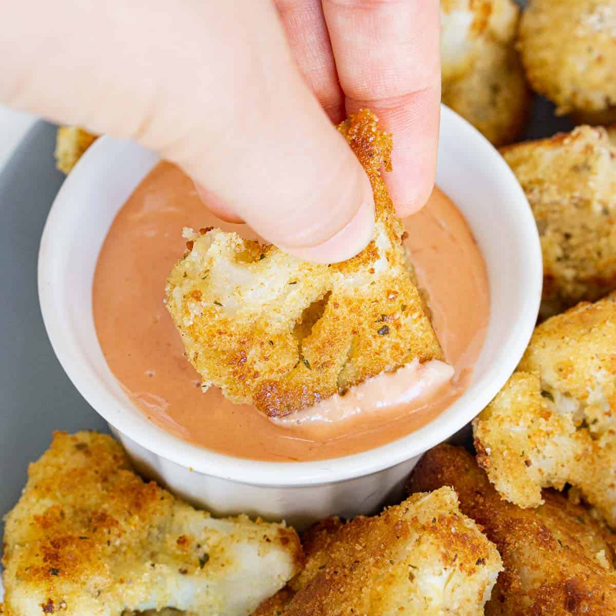 Dipping vegan fried cauliflower into vegan mayo + ketchup sauce.