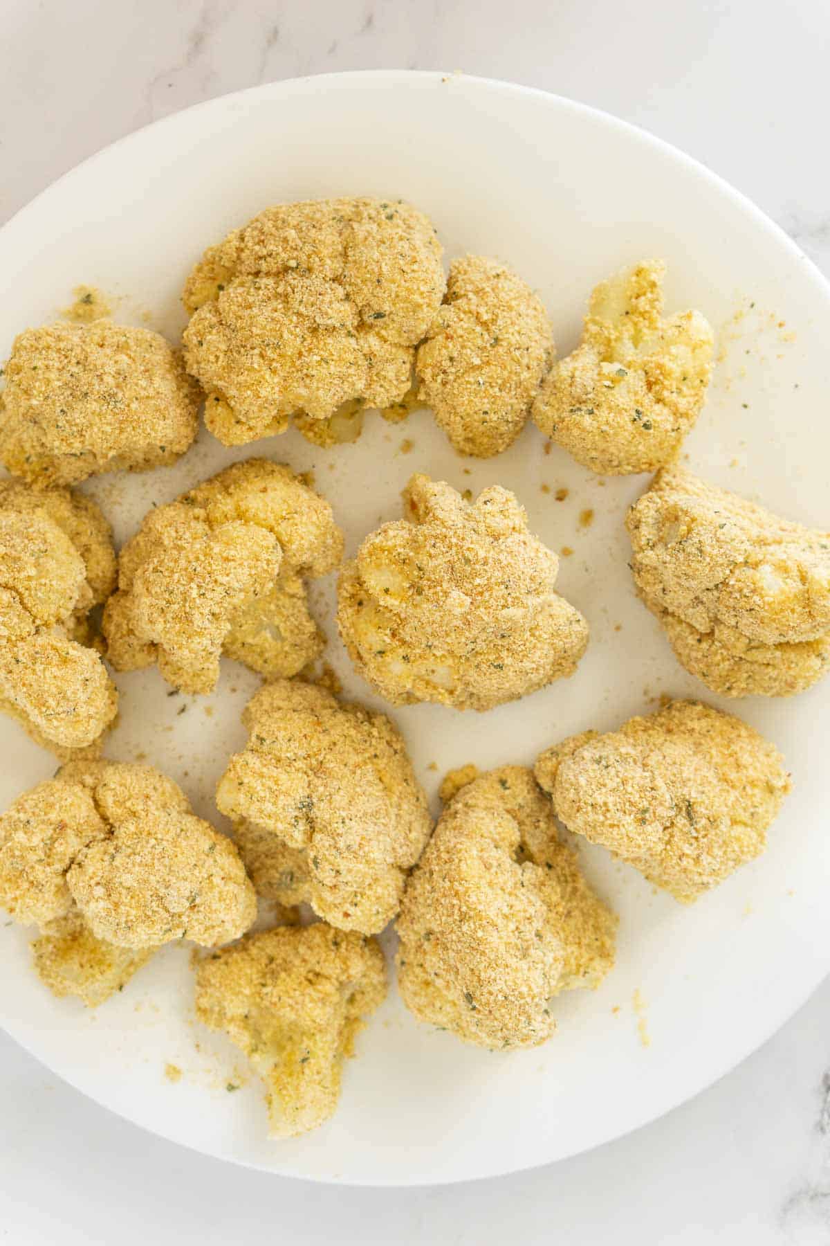 Breaded cauliflower florets on a plate.