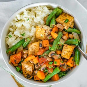 Bowl of black eyed peas, tofu, and green beans over rice,