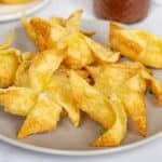 Fried vegan crab rangoon on a plate.