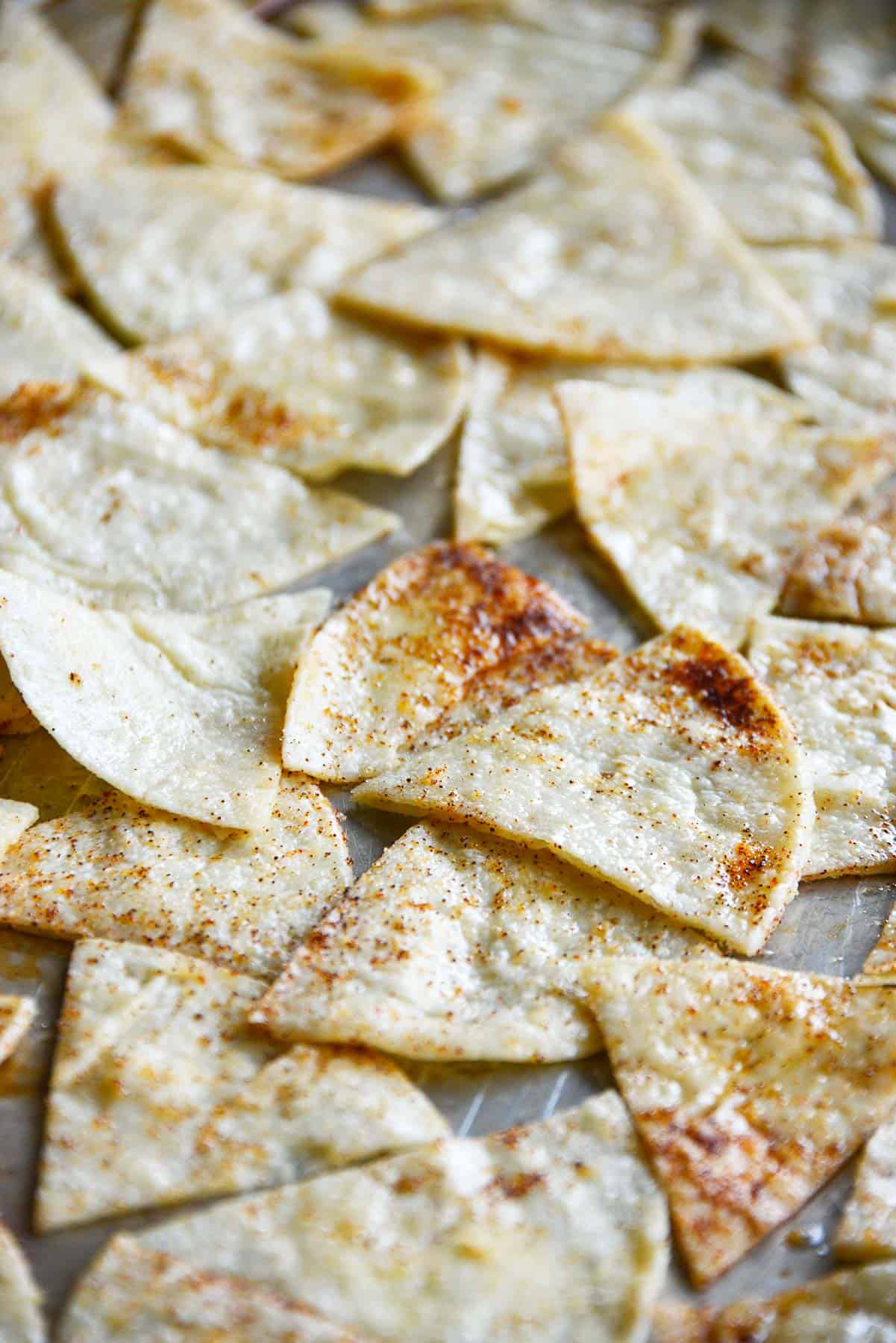 Seasoned tortilla wedges on a baking sheet