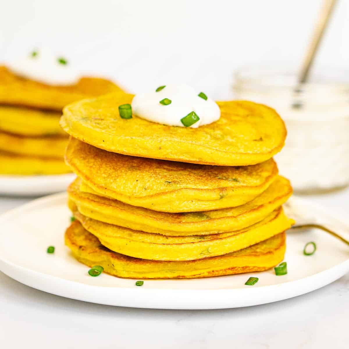 Stack of vegan savory mung bean pancakes with scallions.