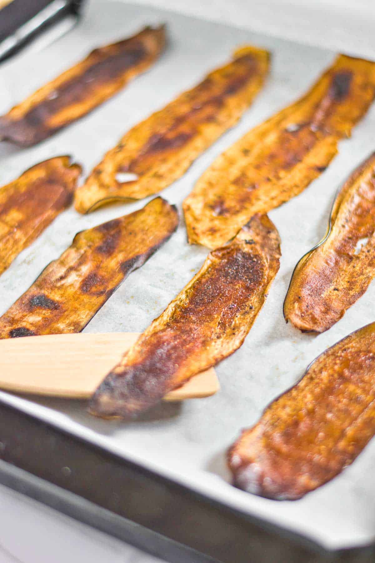 Eggplant bacon slices on a baking pan