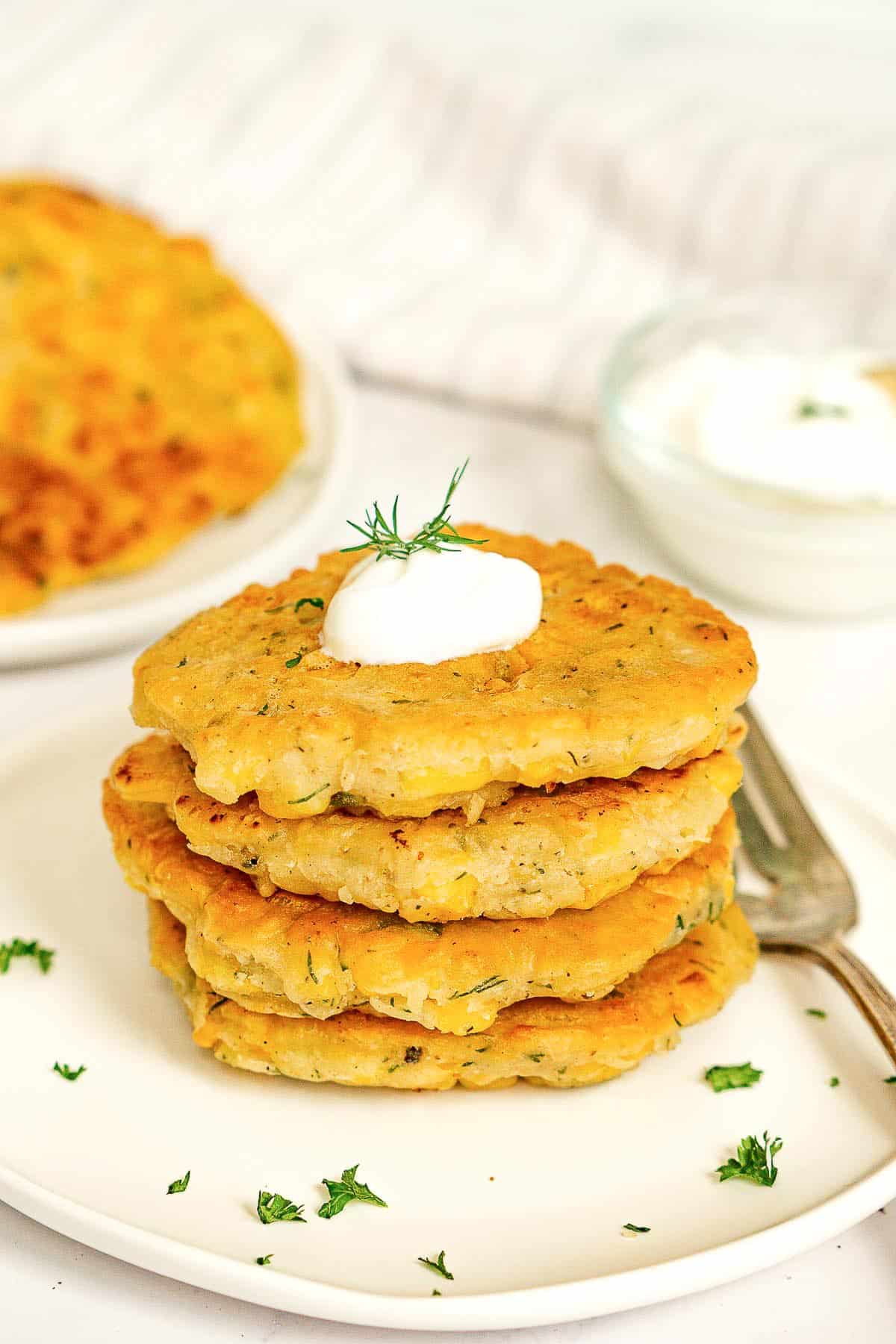 Stack of vegan corn fritters on a plate