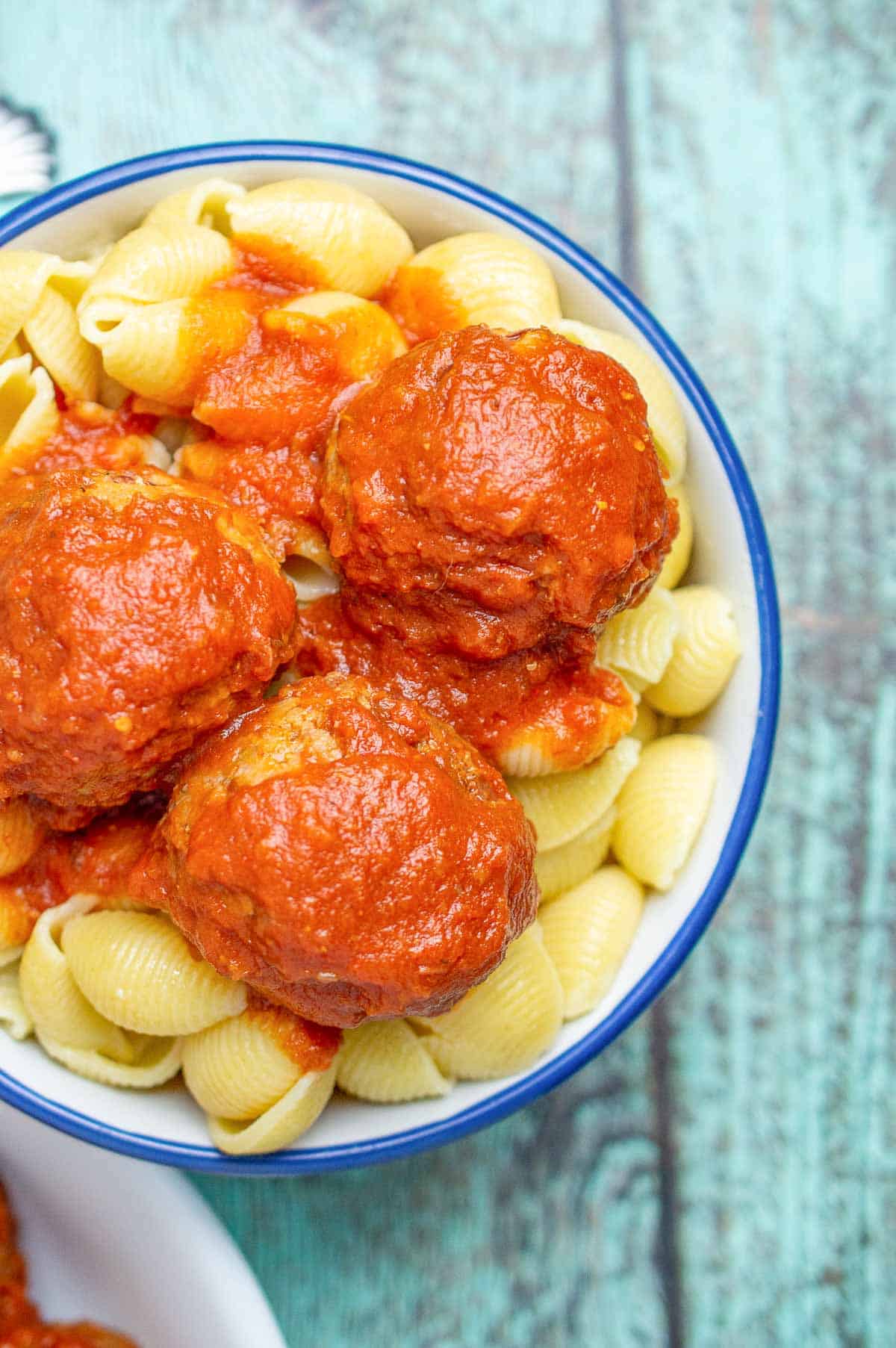 Overhead picture of vegan meatless meatballs in marinara sauce over pasta