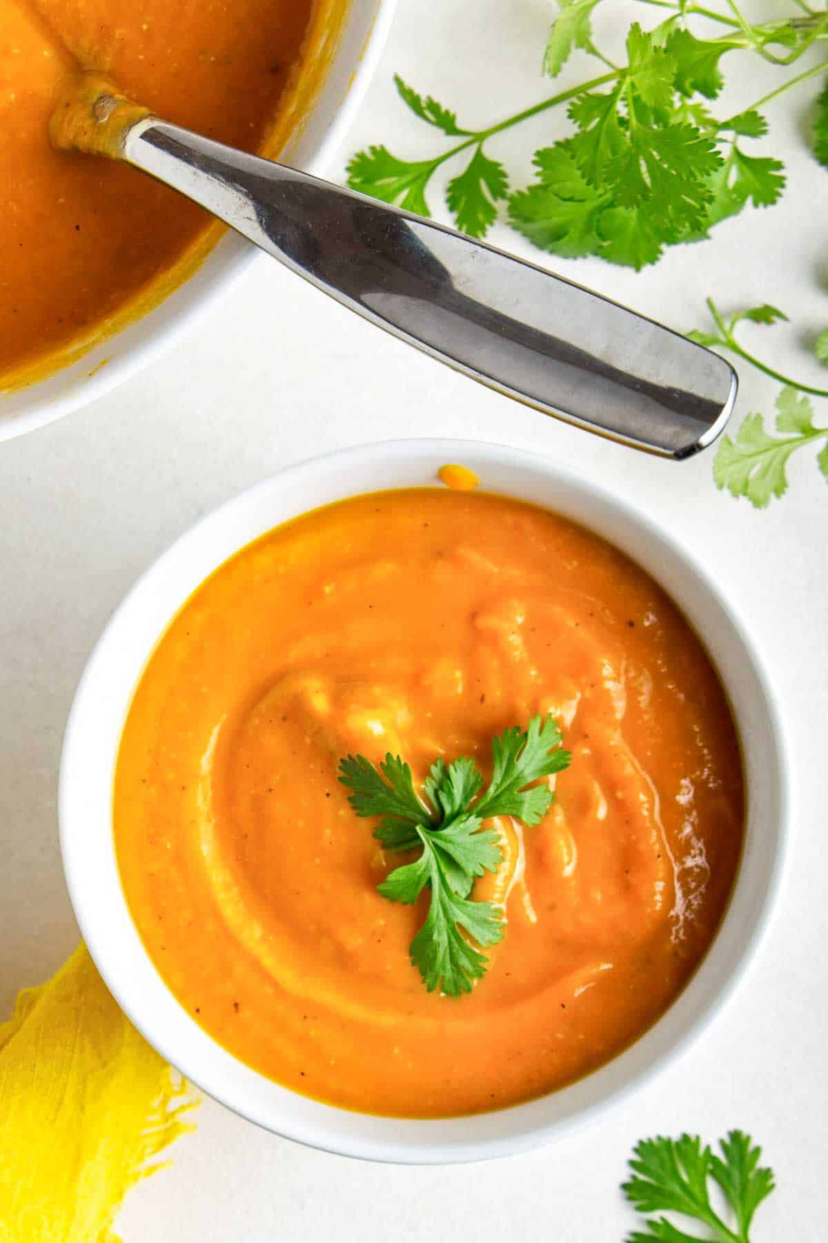 Bowl of sweet potato miso soup garnished with cilantro.