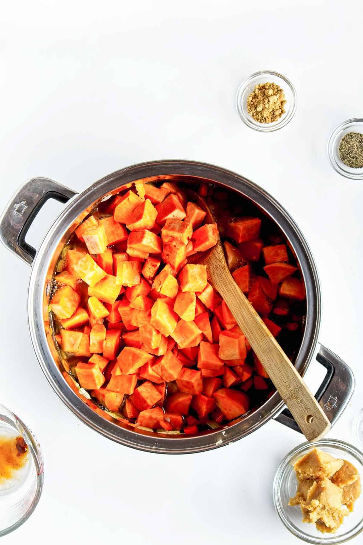 Cubed sweet potatoes added to pot.