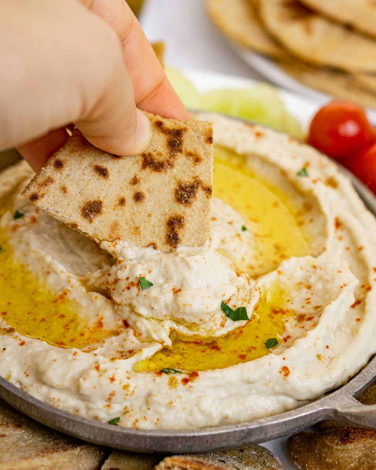 Dipping pita into butterbean hummus