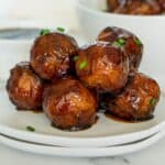 Stack of vegan glazed meatballs on a plate.