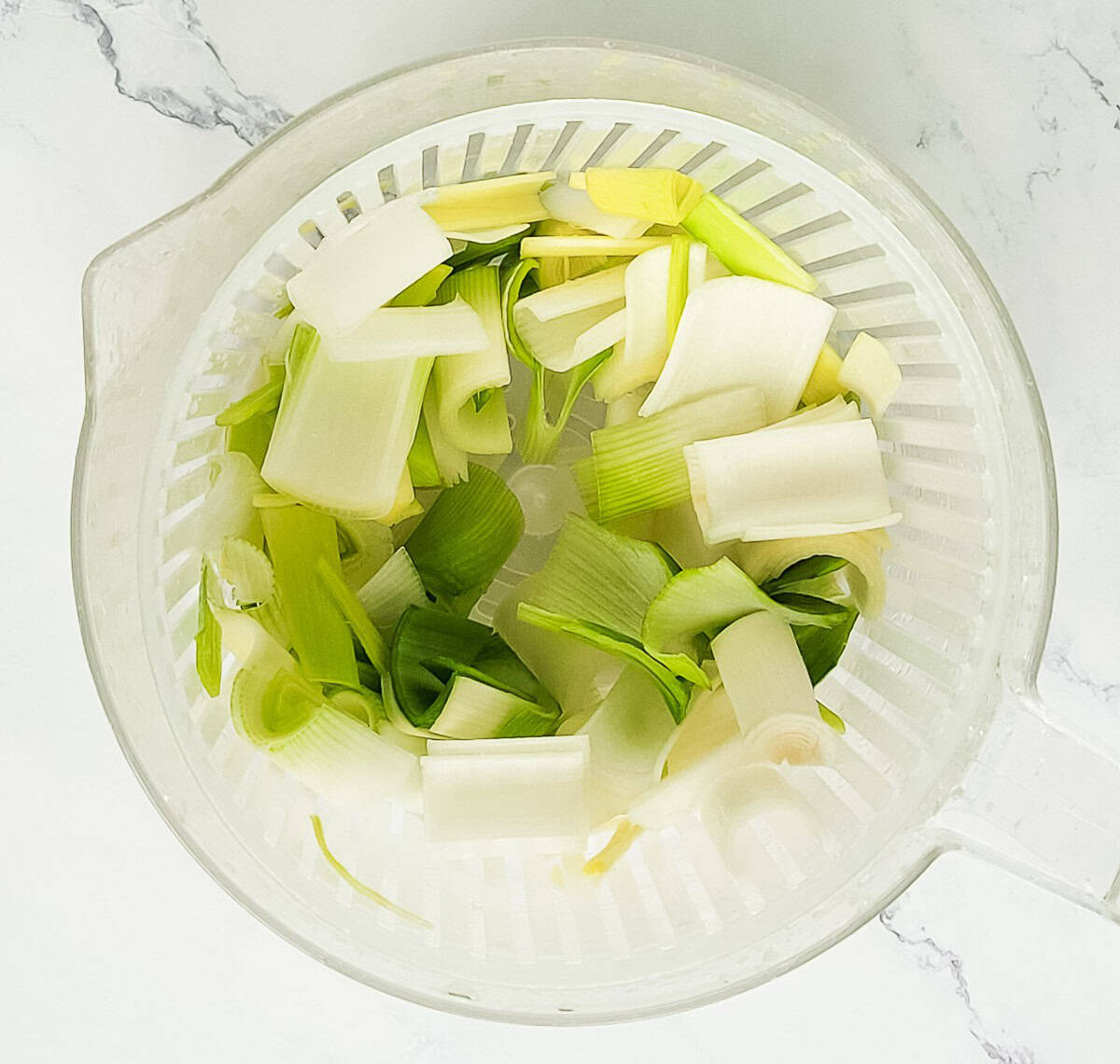 Cleaned leeks in a salad spinner