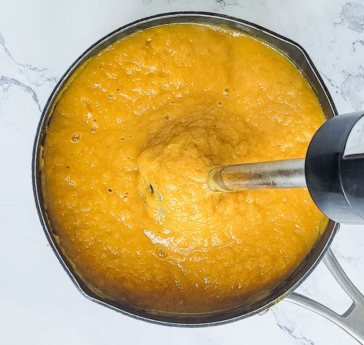 Pureeing butternut squash soup in a pot