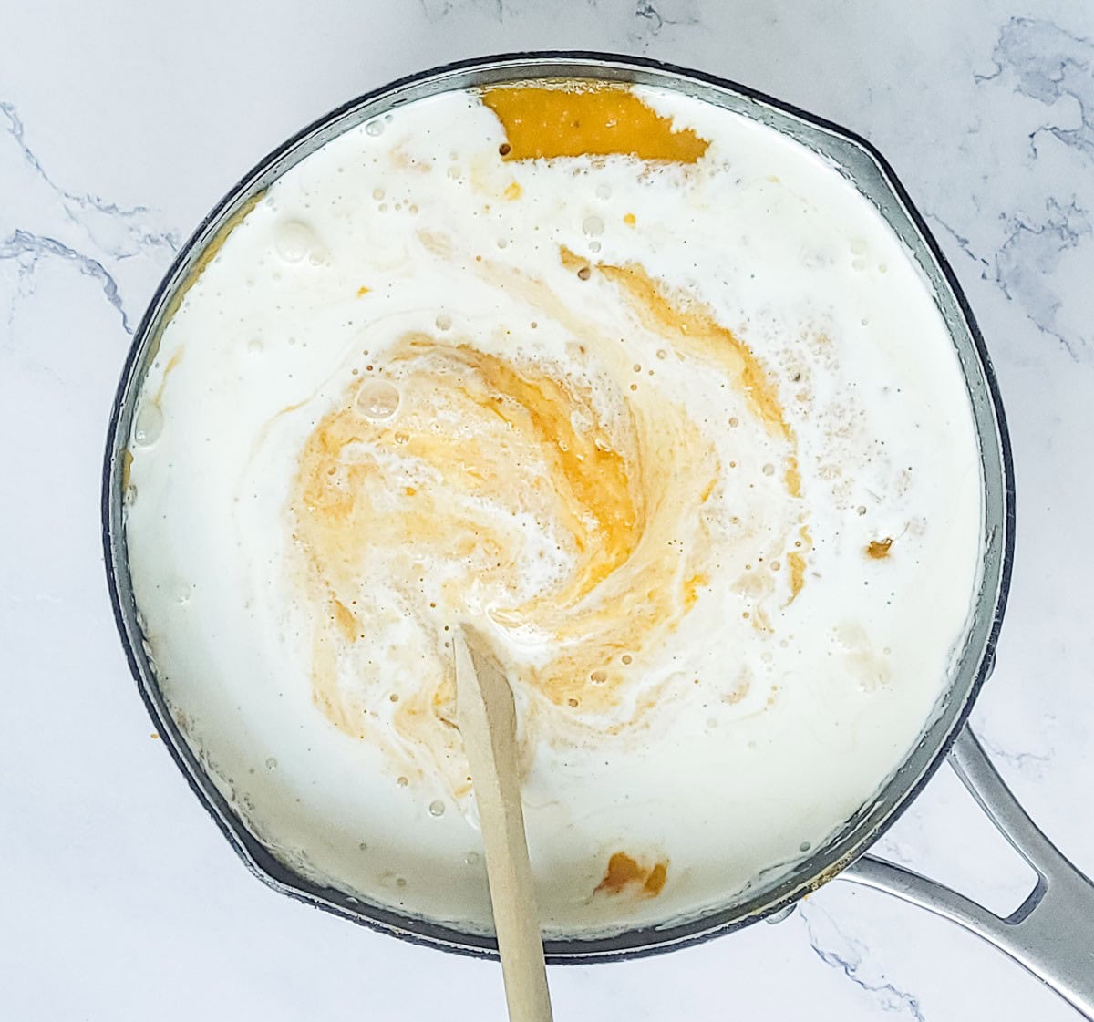 Adding coconut milk to butternut squash soup