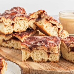 Slices of cinnamon roll focaccia bread on a cutting board