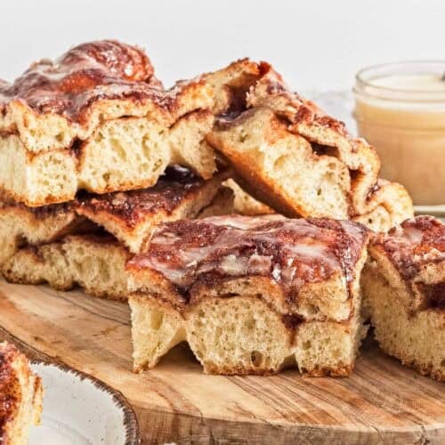 Slices of cinnamon roll focaccia bread on a cutting board