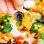 Pinterest image with text: The best loaded vegan nachos with vegan nacho cheese
